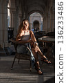 Woman, Chair, Cafe - A woman sitting in a chair in a cafe during the daytime. 136233486