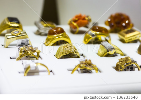A collection of gold rings in a display box at a jewellery shop 136233540