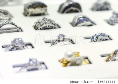 A collection of diamond rings in a display box at a jewellery shop 136233543