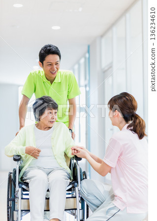 Image of a senior woman in a wheelchair and a caregiver 136234610