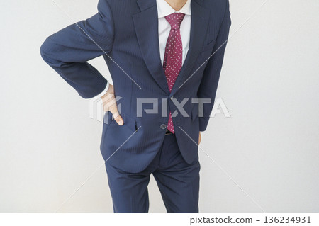 Image of a man in a suit with back pain Image of a man in a suit with back pain 136234931