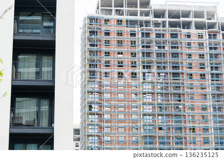 Construction of a building using scaffolding. Construction of a building using scaffolding. 136235125