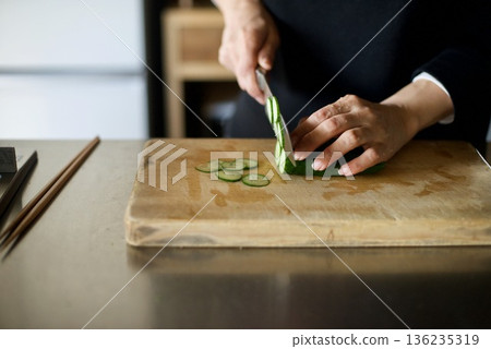 Slicing cucumbers with a knife Slicing cucumbers with a knife 136235319