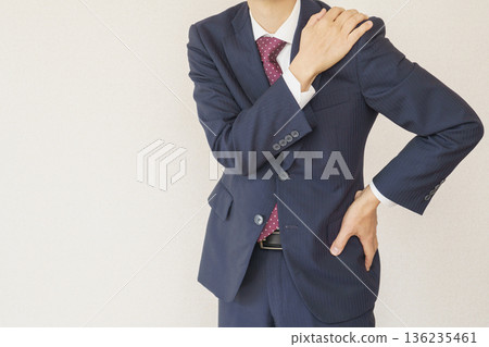 Image of a businessman suffering from back pain and stiff shoulders Image of a businessman suffering from back pain and stiff shoulders 136235461