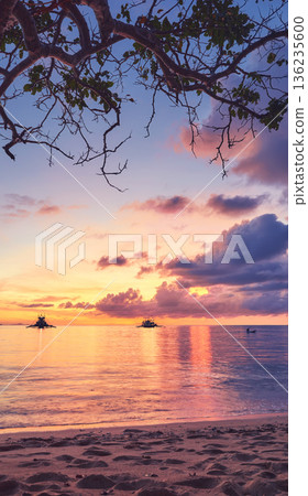A beautiful sunset seen from the beach on one of the small islands of the Philippines. 136235600