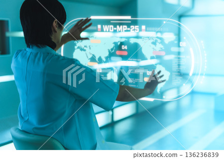 Researcher manipulates holographic world map in blue light Researcher manipulates holographic world map in blue light 136236839