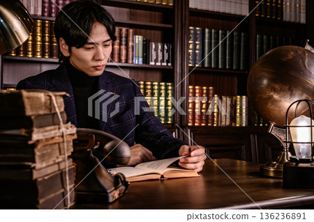 In his study, surrounded by antique globes and lamps 136236891
