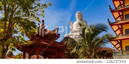 Buddha statue surrounded pagdas at Chua Hue Chieu temple in Kontum, Vietnam, Panorama Buddha statue surrounded pagdas at Chua Hue Chieu temple in Kontum, Vietnam, Panorama 136237503