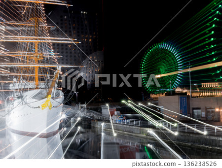 Night view with a Ferris wheel and trails of light Night view with a Ferris wheel and trails of light 136238526