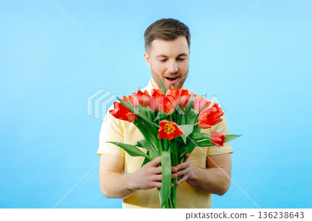 Man holding bunch of red flowers 136238643