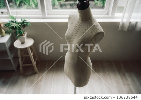 Lace-patterned torso and windowsill 136238644