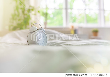 Alarm clock on the bed Alarm clock on the bed 136238664