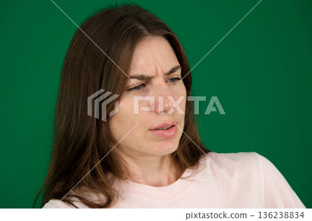 surprised woman sad eyes Portrait of a scared or very surprised girl on a white studio background. 136238834