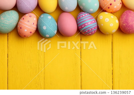 Colorful Easter Egg side border over a bright yellow wood background. Copy space. Colorful Easter Egg side border over a bright yellow wood background. Copy space. 136239057