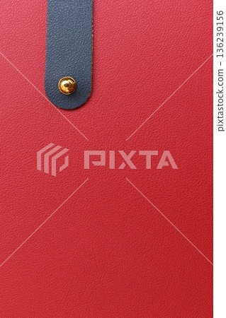 shiny red leather background with dark blue strap 136239156