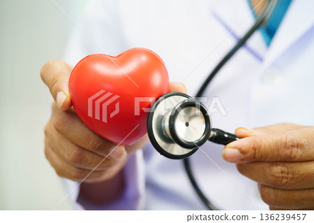 Asian woman doctor holding red heart for health in hospital. 136239457