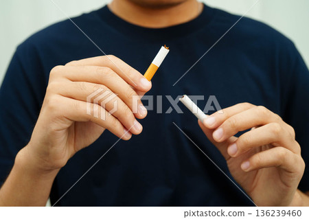 Quit smoking, Asian teenage man breaking destroy cigarette in hand. Quit smoking, Asian teenage man breaking destroy cigarette in hand. 136239460