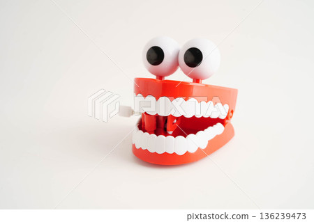 Funny red teeth with eye toy denture model for dental health care. 136239473