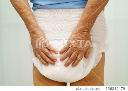 Asian senior woman patient wearing adult incontinence diaper pad in hospital. Asian senior woman patient wearing adult incontinence diaper pad in hospital. 136239479