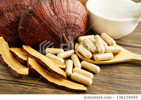 Lingzhi or Reishi mushroom with capsules, organic natural healthy food. Lingzhi or Reishi mushroom with capsules, organic natural healthy food. 136239489