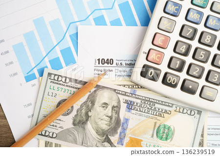 Tax form 1040 U.S. Individual Income Tax Return with dollar banknotes money. Tax form 1040 U.S. Individual Income Tax Return with dollar banknotes money. 136239519