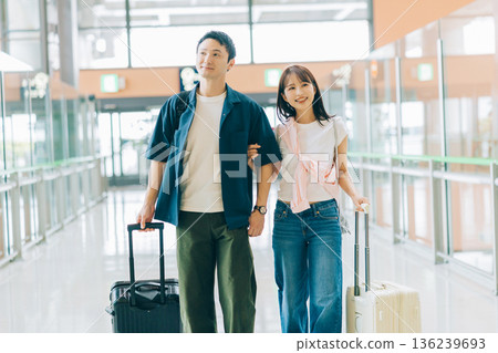 A couple at the airport about to depart on a trip (Photography courtesy of Kansai International Airport (KIX)) A couple at the airport about to depart on a trip (Photography courtesy of Kansai International Airport (KIX)) 136239693