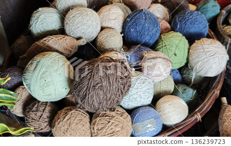 A group of yarns dyed with indigo and natural colors used in handicrafts and weaving. 136239723