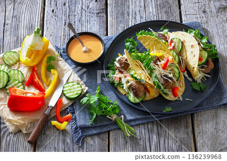 Lamb meatball tacos with fresh veggies on a plate 136239968