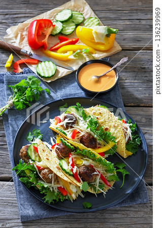 Lamb meatball tacos with fresh veggies on a plate 136239969