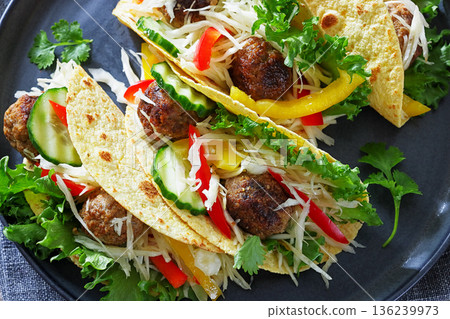 Beef meatball tacos with fresh veggies on a plate Beef meatball tacos with fresh veggies on a plate 136239973