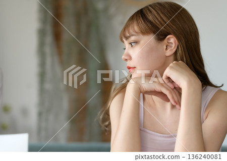 Profile of a pensive woman Profile of a pensive woman 136240081