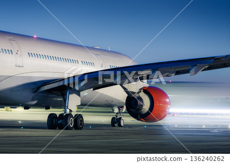 Commercial airplane during taxiing on taxiway to airport runway for take off 136240262