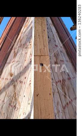 Muscat, Oman - December 15, 2025: Of Precise Plywood Fitting Against Outdoor Sky Background. Skilled Workers Precisely Installing Marine Grade Sheathing Panels Under Open Sky With Tools And Clamps 136240283