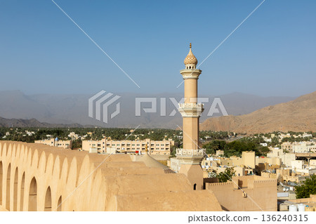 Nizwa Fort walls and Al Qalaa Mosque in afternoon light in Oman 136240315
