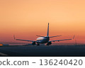 Airplane at airport at golden sunrise 136240420