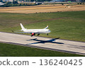 Airplane landing on airport runway 136240425