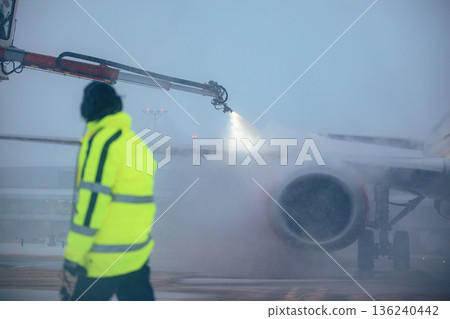 Deicing of airplane before flight at airport Deicing of airplane before flight at airport 136240442