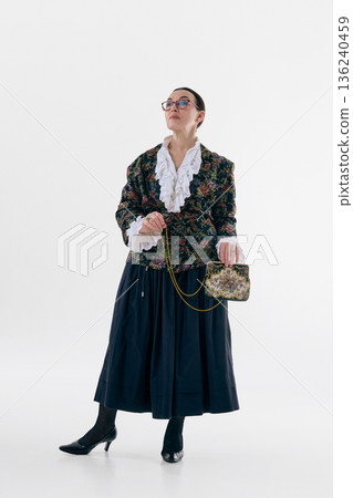 Elegant woman in floral jacket studio portrait with serene confidence. Elegant woman in floral jacket studio portrait with serene confidence. 136240459