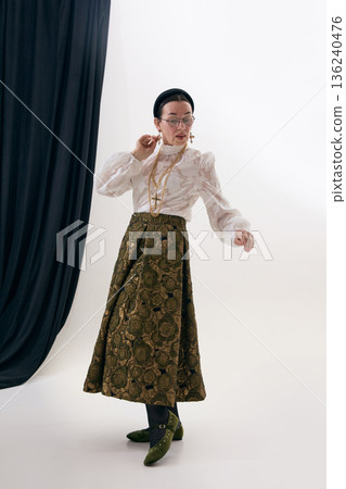 Vintage fashion portrait of woman highlighting classic poetcore outfit. 136240476
