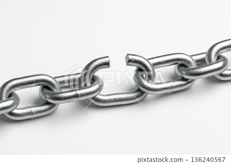 A Close-Up View of a Broken Metallic Chain Link Illustrating Strength and Vulnerability in Structural Integrity and Connection 136240567