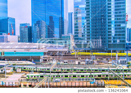 Tokyo cityscape in Japan. View of the Shinkansen bullet train Doctor Yellow, which brings good luck, Tokyo Station, trains, Yaesu and other buildings. Tokyo cityscape in Japan. View of the Shinkansen bullet train Doctor Yellow, which brings good luck, Tokyo Station, trains, Yaesu and other buildings. 136241064