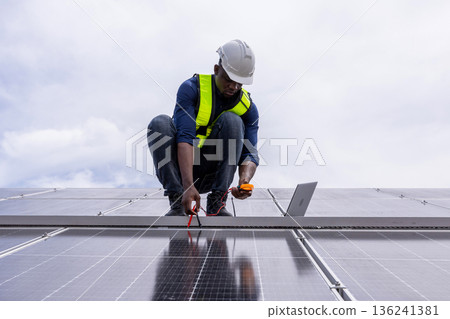 Engineer service check installation solar cell on the roof of factory. 136241381