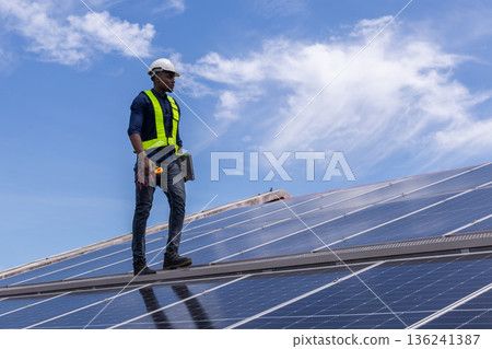 Engineer service check installation solar cell on the roof of factory. 136241387