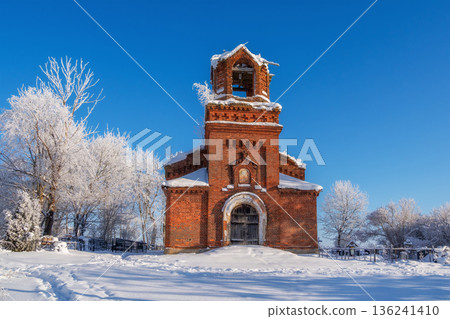 small red brick church with a bell tower and a snow covered roof small red brick church with a bell tower and a snow covered roof 136241410