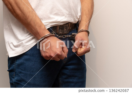 Close up of male hands in handcuffs. 136242087