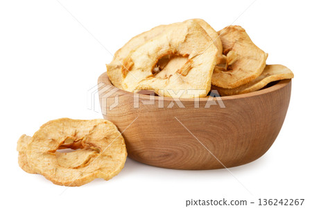 Dried apples in a wooden plate and a pile on a white background. Isolated Dried apples in a wooden plate and a pile on a white background. Isolated 136242267