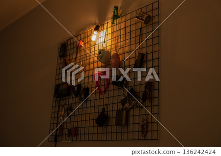 Decorative wall grid with warm Edison light and vintage items Decorative wall grid with warm Edison light and vintage items 136242424
