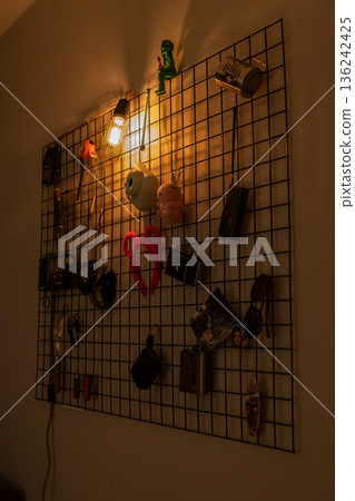 Decorative wall grid with warm Edison light and vintage items Decorative wall grid with warm Edison light and vintage items 136242425