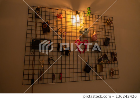 Decorative wall grid with warm Edison light and vintage items Decorative wall grid with warm Edison light and vintage items 136242426