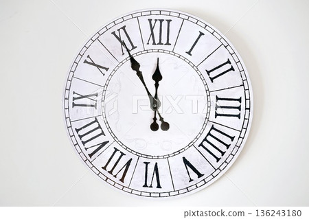 A white clock with roman numerals and the word England on it A white clock with roman numerals and the word England on it 136243180